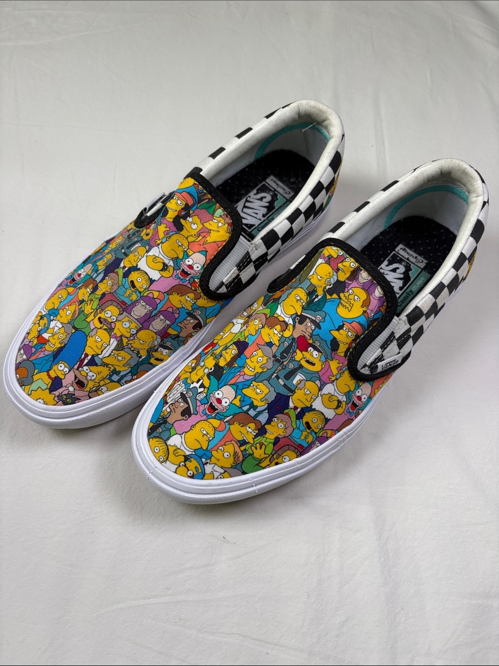 Vans Slip-On Sneakers in Yellow Multi with Black-White Checker Trim. Simpsons